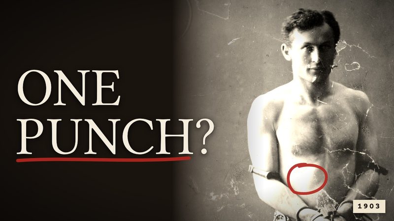 Houdini, bare-chested and handcuffed in a photograph from 1903, with a red pencil circle on his stomach, beside the words: One punch?